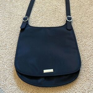 Nine West black nylon crossbody messenger bag featuring a flap closure